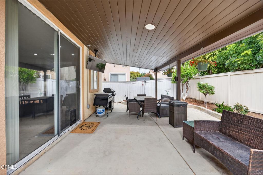 816 Noontide Way Oxnard, CA 93035 - Photo 29 of 41 a living room with patio furniture and a floor to ceiling window