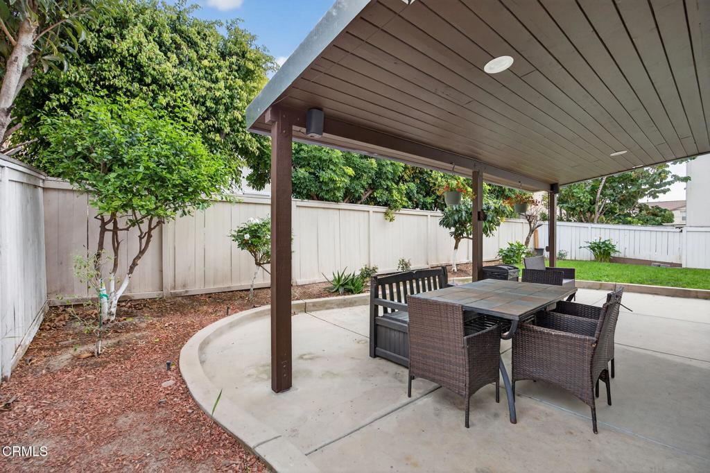 816 Noontide Way Oxnard, CA 93035 - Photo 32 of 41 a view of a patio with a table chairs and a backyard