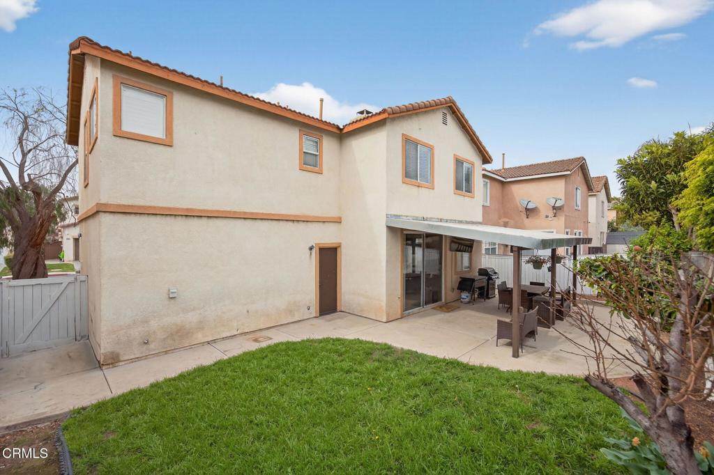 816 Noontide Way Oxnard, CA 93035 - Photo 34 of 41 a view of a white house with a big yard and potted plants