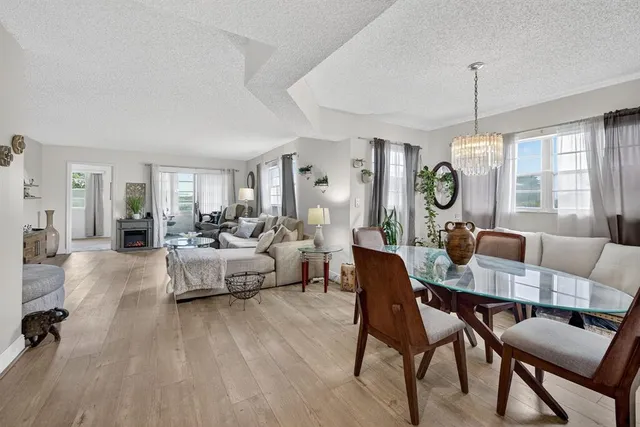 a living room with furniture dining area and a window