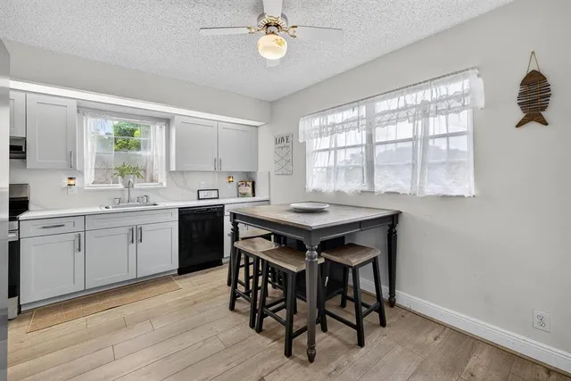 a kitchen with a table chairs sink and cabinets
