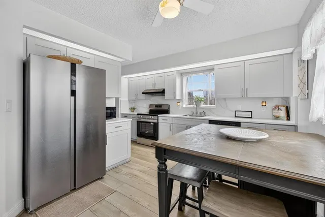 a kitchen with a sink appliances and cabinets