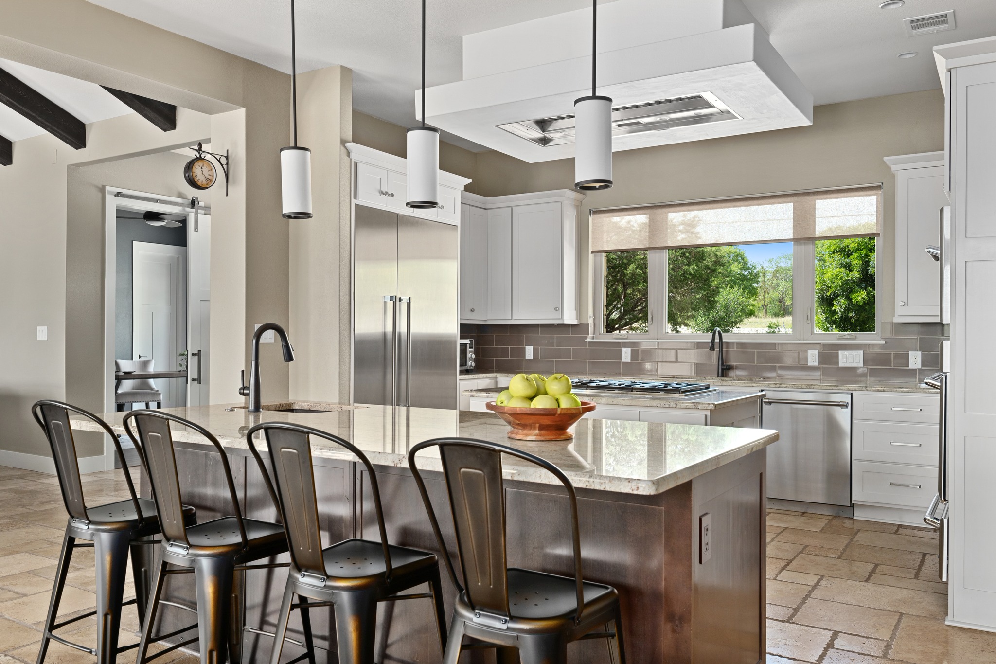 1001 La Cantera Leander, TX 78641 - Photo 11 of 40 a kitchen with stainless steel appliances granite countertop a dining table chairs stove and sink