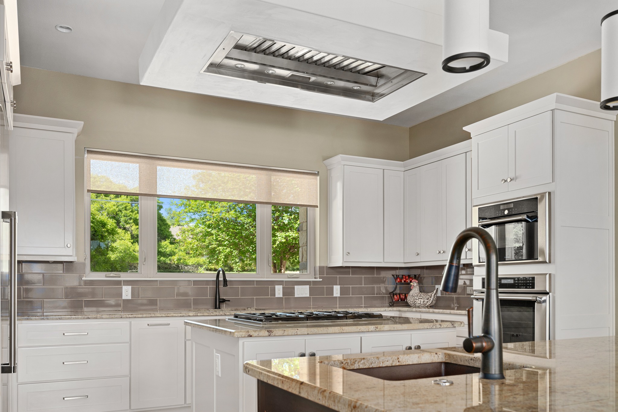 1001 La Cantera Leander, TX 78641 - Photo 13 of 40 a kitchen with granite countertop a sink stainless steel appliances and cabinets