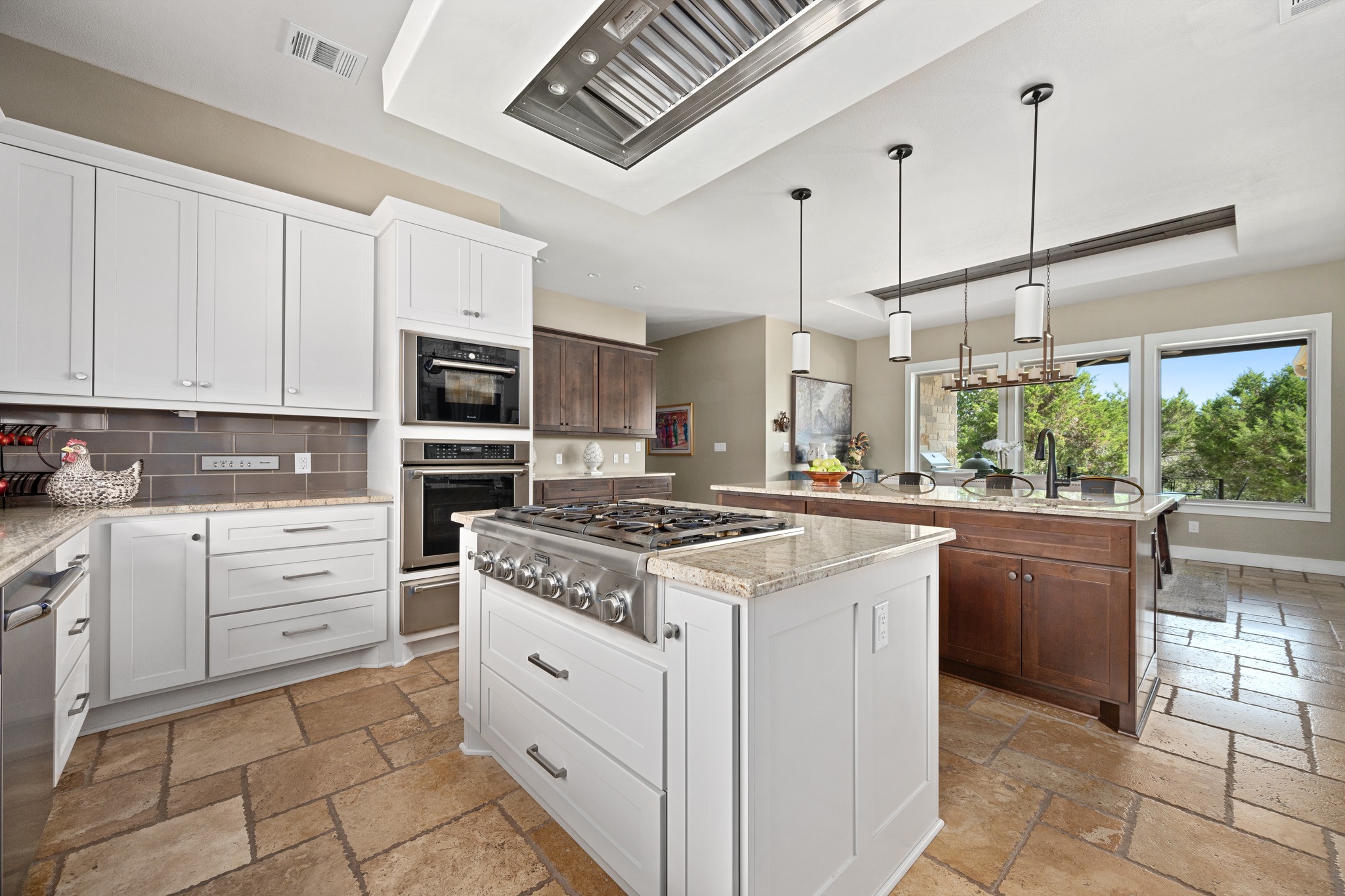 1001 La Cantera Leander, TX 78641 - Photo 14 of 40 a kitchen with stainless steel appliances granite countertop a stove a sink and a refrigerator