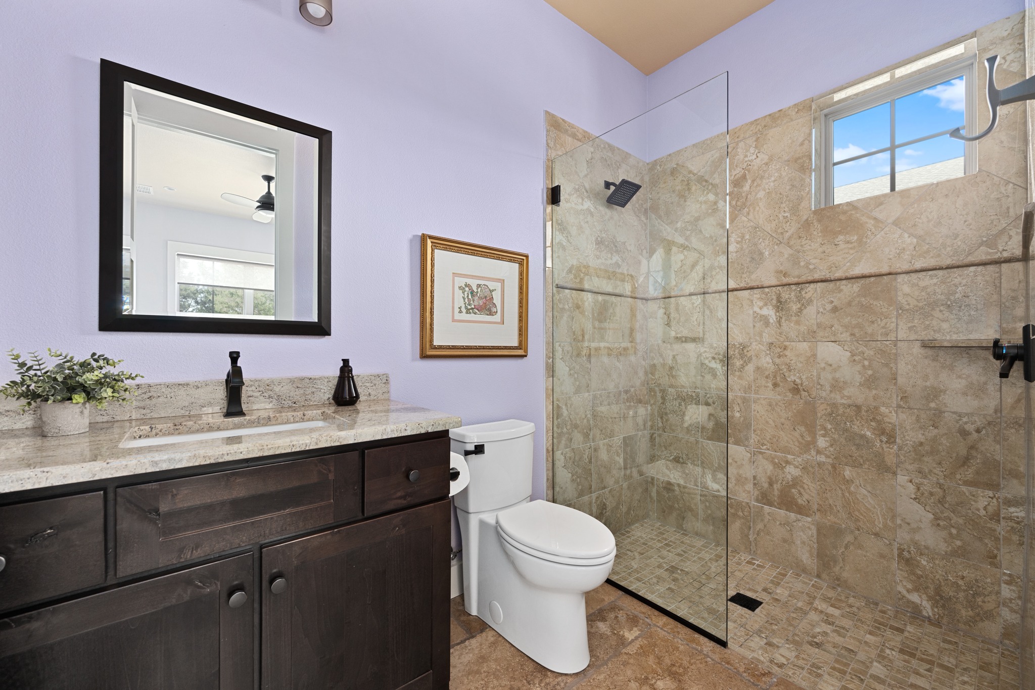 1001 La Cantera Leander, TX 78641 - Photo 23 of 40 a bathroom with a granite countertop sink mirror a toilet and a shower