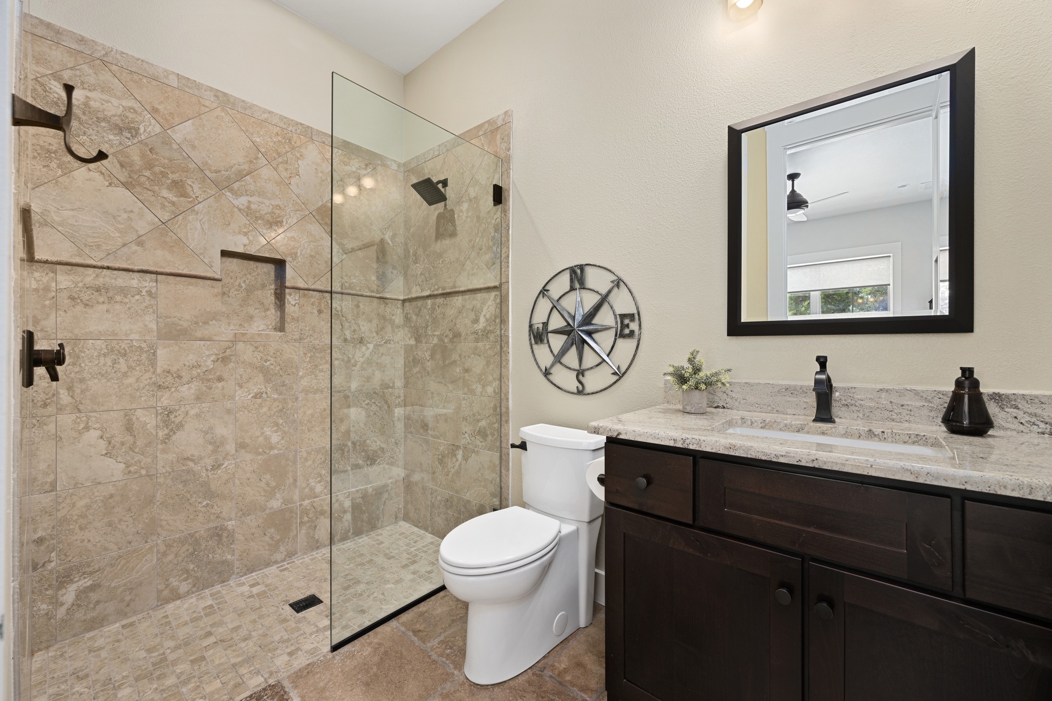 1001 La Cantera Leander, TX 78641 - Photo 25 of 40 a bathroom with a granite countertop toilet sink and mirror