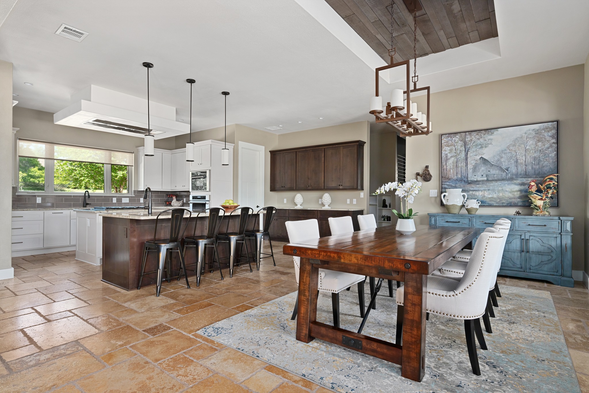 1001 La Cantera Leander, TX 78641 - Photo 9 of 40 a dining hall with stainless steel appliances kitchen island granite countertop a table chairs and a kitchen view