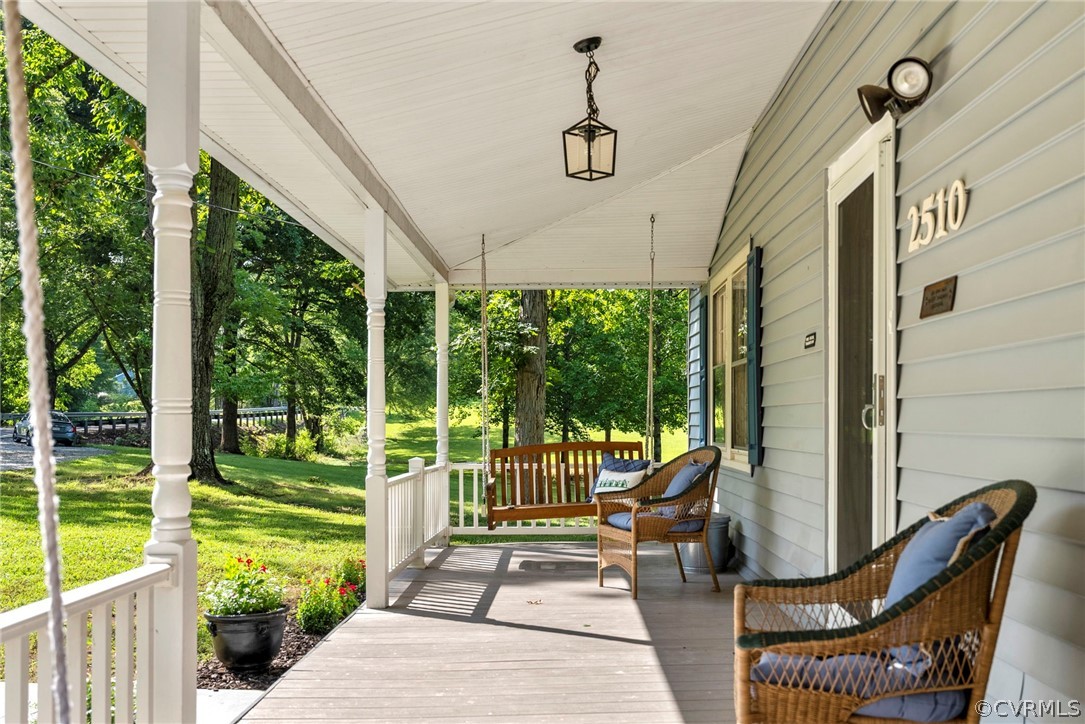 2510 Broad St Road Gum Spring, VA 23065 - Photo 7 of 44 a view of a patio with a table chairs and a floor to ceiling window