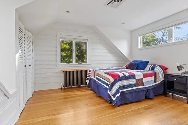 a bedroom with a bed closet and window