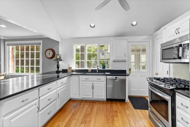a kitchen with stainless steel appliances granite countertop a stove and a sink
