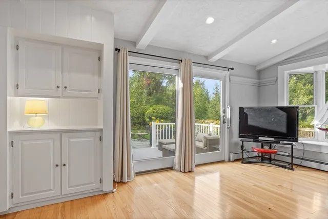 a view of room with wooden floor and windows