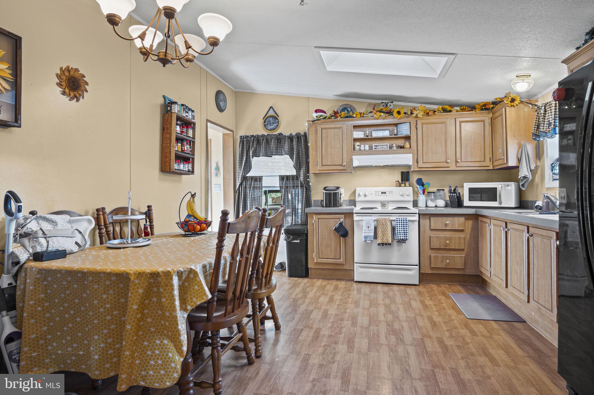 70 Pine Road Newville, PA 17241 - Photo 6 of 27 a kitchen with stainless steel appliances granite countertop a refrigerator a sink dishwasher a stove and white cabinets with wooden floor