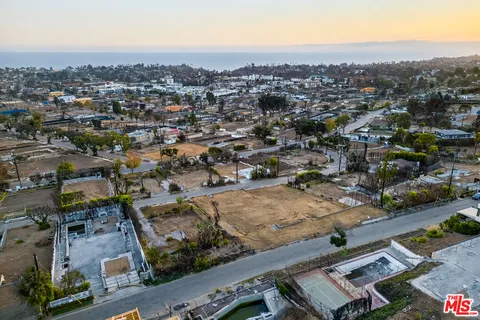 an aerial view of residential houses with city view
