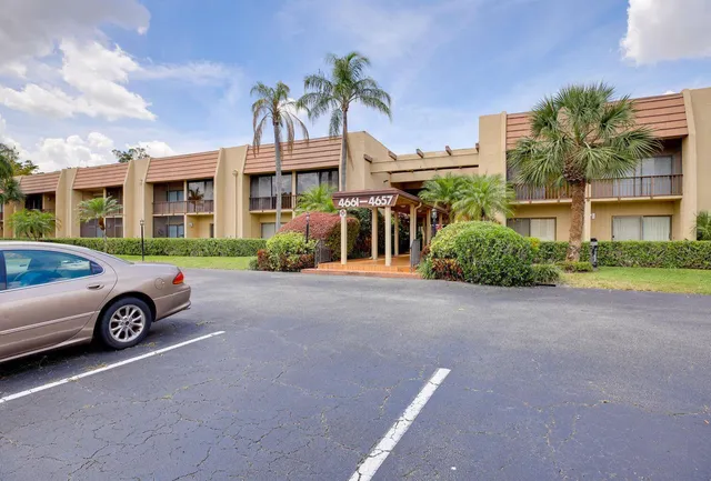 a front view of a house with parking space