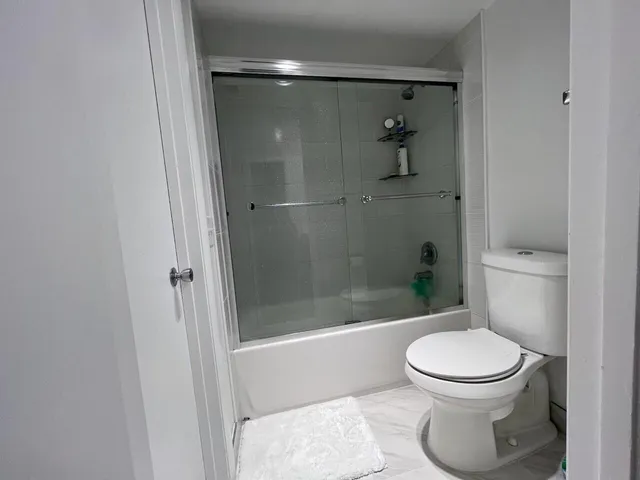 a bathroom with a toilet and a shower