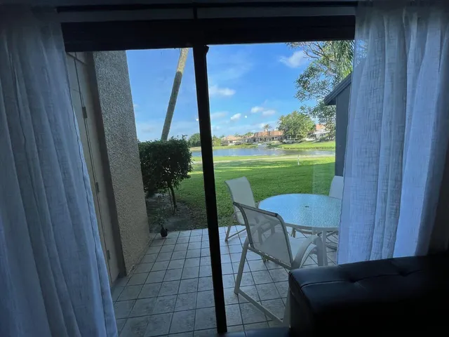 a view of a porch with furniture and garden
