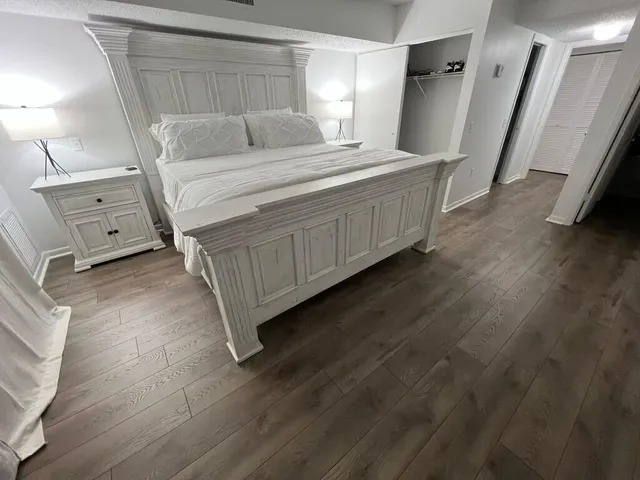 a bedroom with a bed and a mirror