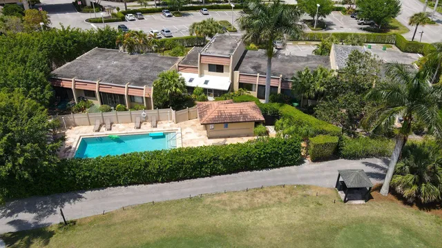 an aerial view of a house with garden space and lake view