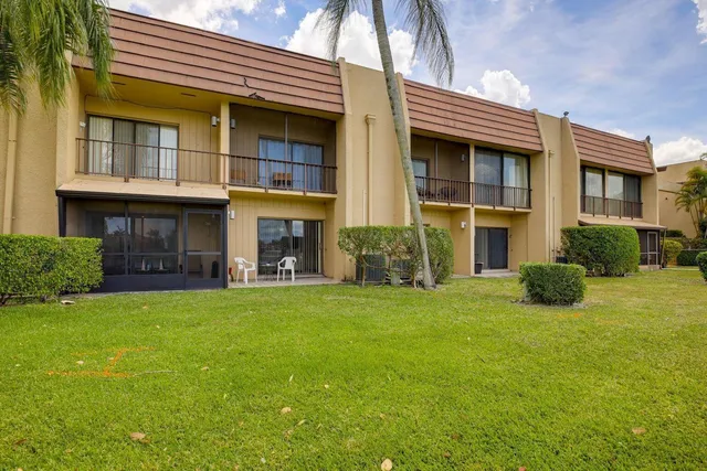 a view of an house with backyard and porch