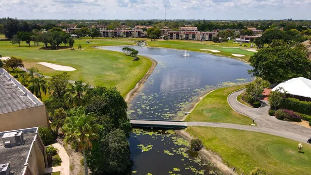 an aerial view of a swimming pool with a yard