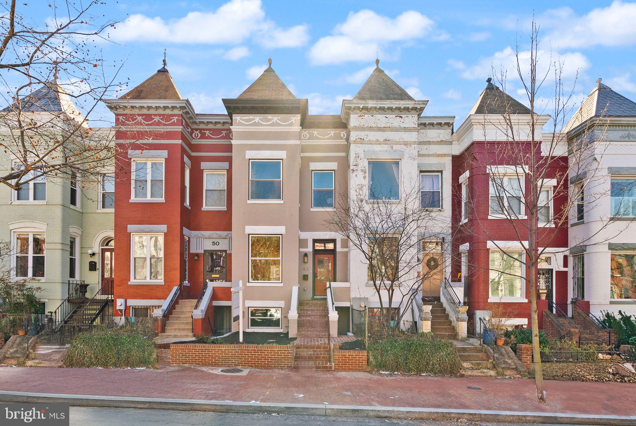 a front view of a residential apartment building with a yard