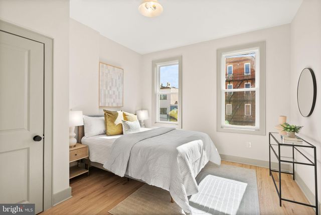 a bedroom with a bed a mirror and furniture