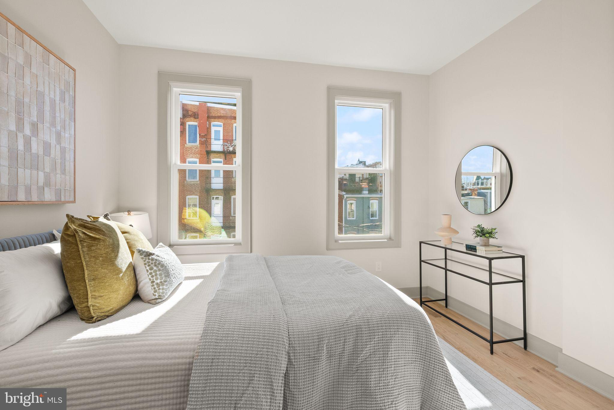 52 S Street Northwest Washington, DC 20001 - Photo 17 of 30 a bedroom with a bed a mirror and a window