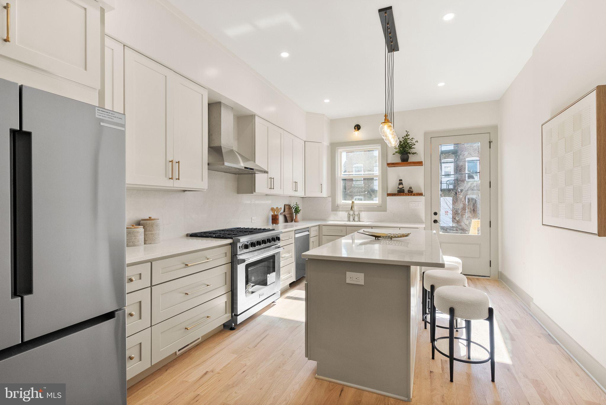 52 S Street Northwest Washington, DC 20001 - Photo 8 of 30 a kitchen with white cabinets and stainless steel appliances