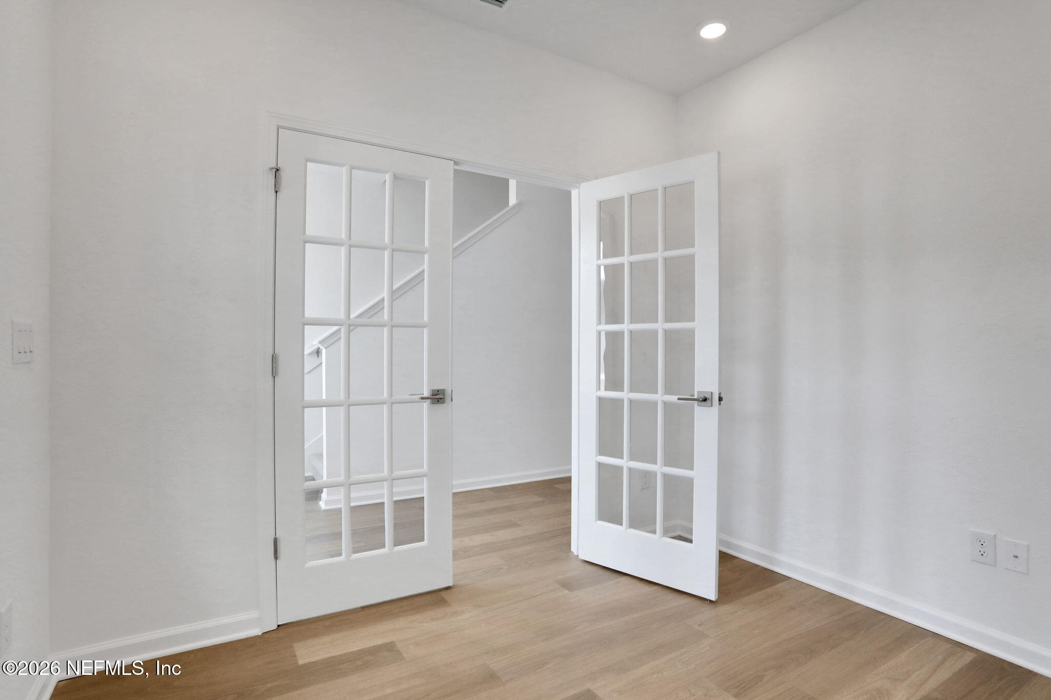 3154 Gadwall Road Orange Park, FL 32065 - Photo 6 of 10 an empty room with wooden floor and cabinet