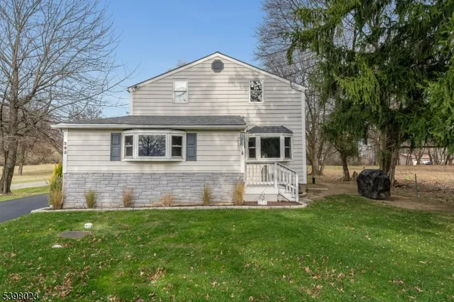 a front view of house with yard and outdoor seating