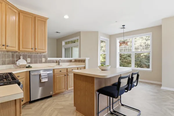 a kitchen with a stove a sink and a refrigerator