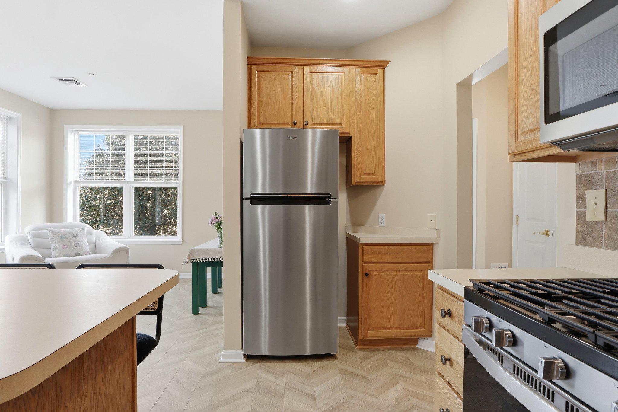 1010 Crest Way, Unit 103 York, PA 17403 - Photo 17 of 49 a kitchen with a refrigerator a stove and a cabinets