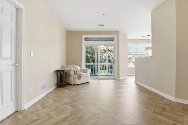 a spacious bedroom with a bed and a large window
