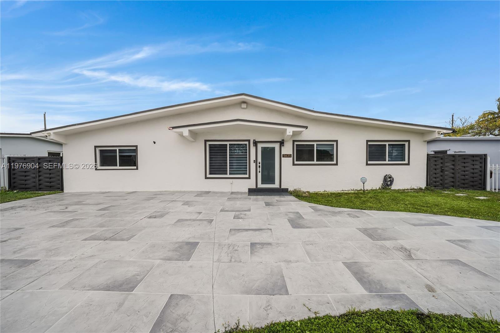 5635 West 13th Court Hialeah, FL 33012 - Photo 1 of 47 a front view of a house with a yard