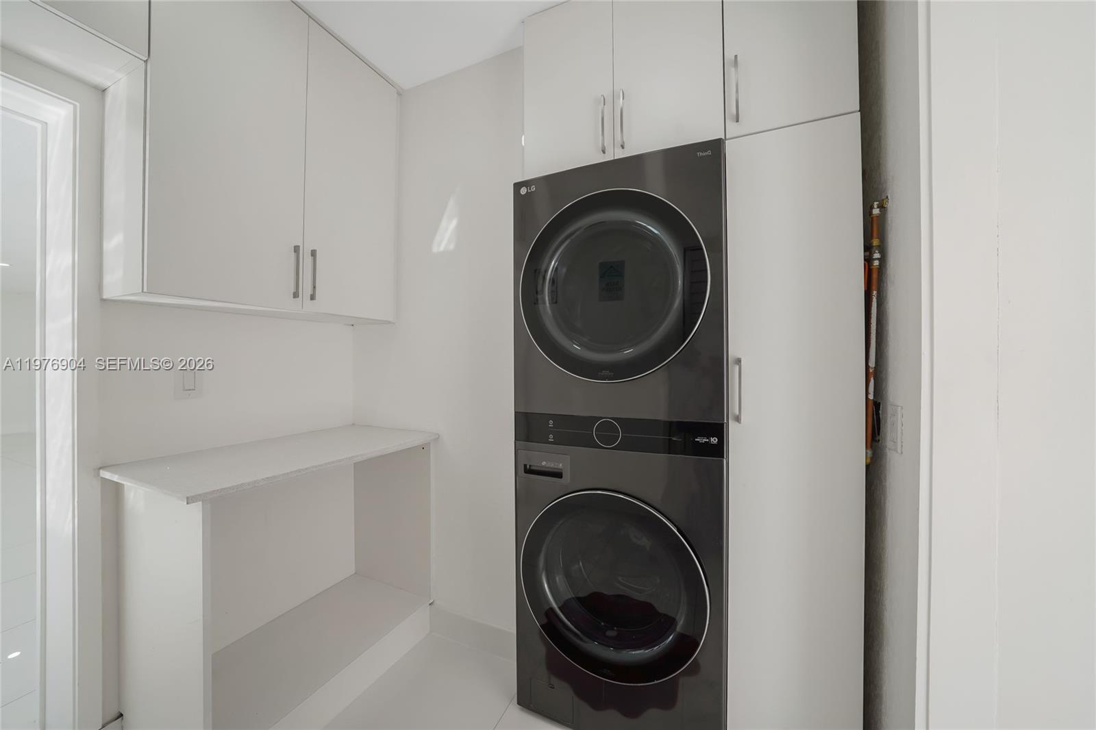 5635 West 13th Court Hialeah, FL 33012 - Photo 15 of 47 a utility room with sink dryer and washer