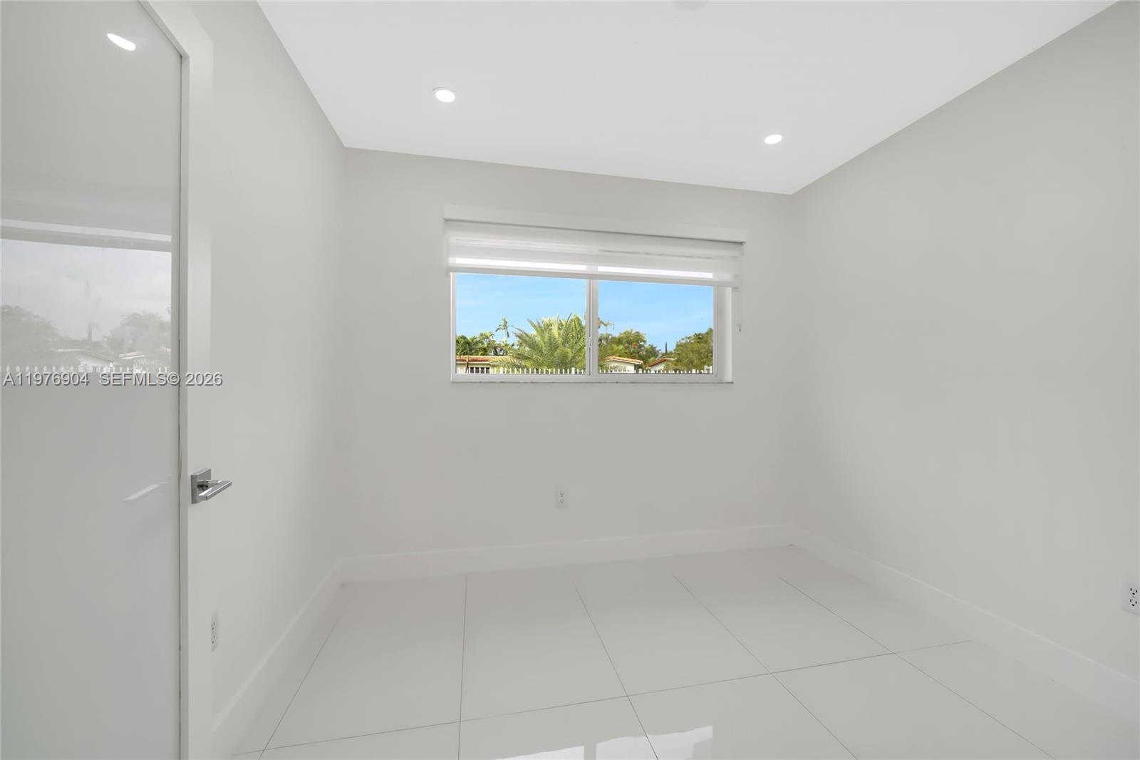 5635 West 13th Court Hialeah, FL 33012 - Photo 20 of 47 a bathroom with a window and a shower