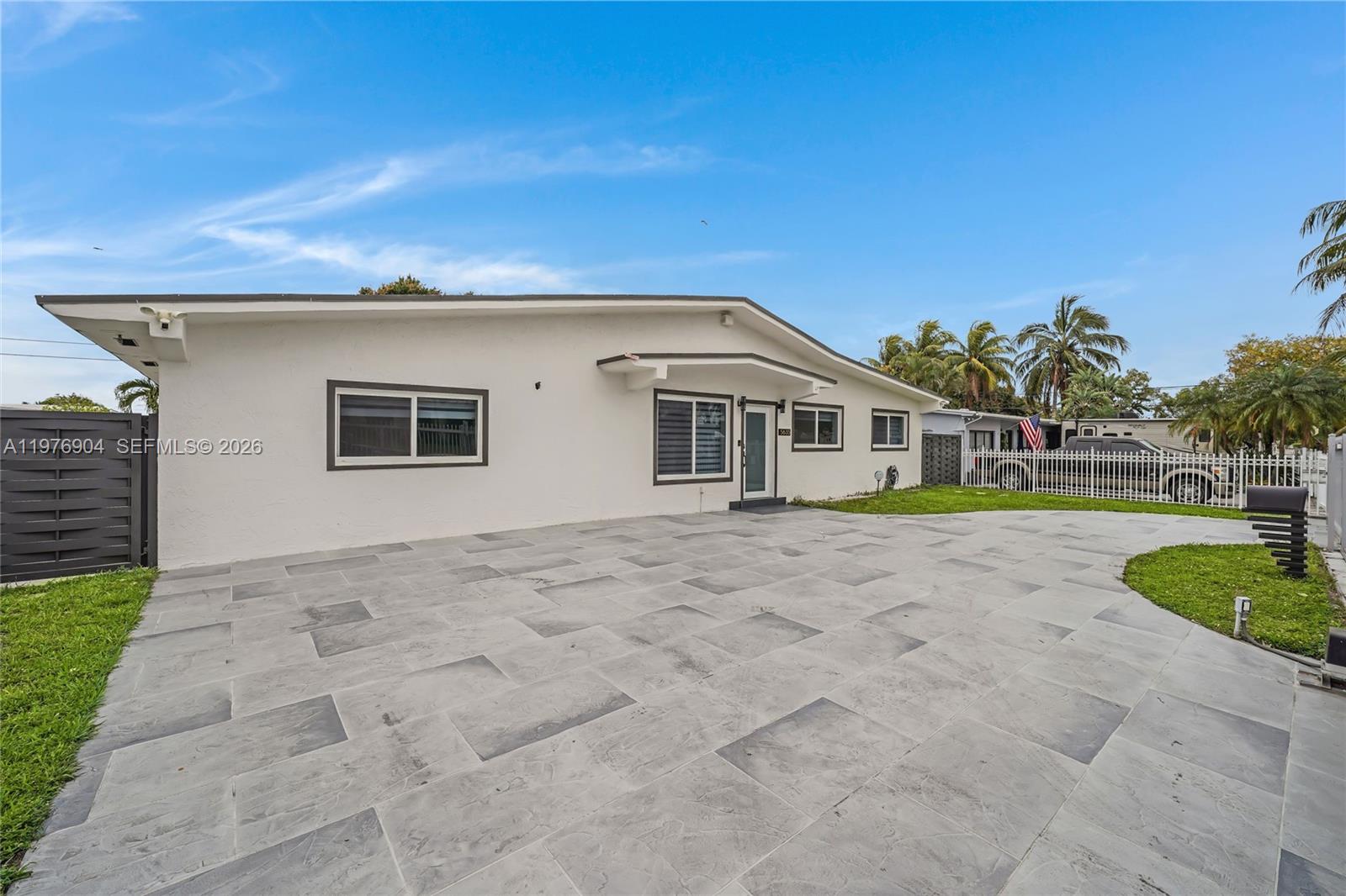 5635 West 13th Court Hialeah, FL 33012 - Photo 2 of 47 a front view of a house with a yard