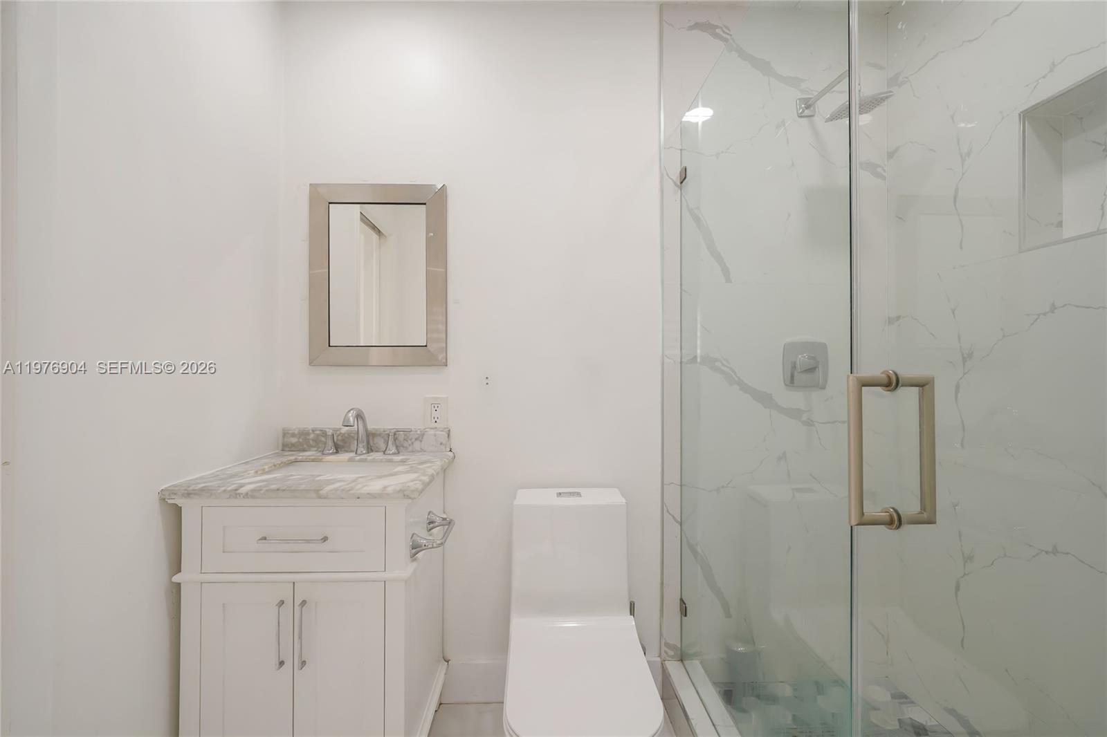 5635 West 13th Court Hialeah, FL 33012 - Photo 24 of 47 a bathroom with a sink a toilet and shower
