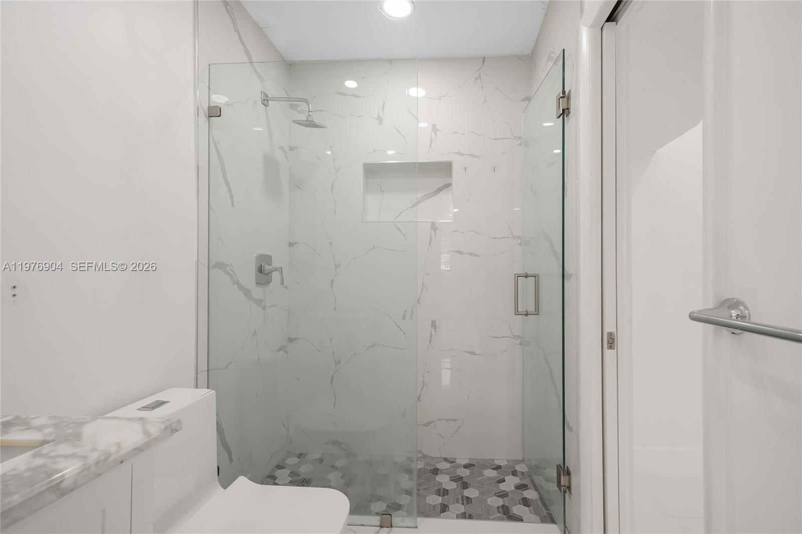 5635 West 13th Court Hialeah, FL 33012 - Photo 27 of 47 a bathroom with a shower a toilet and sink