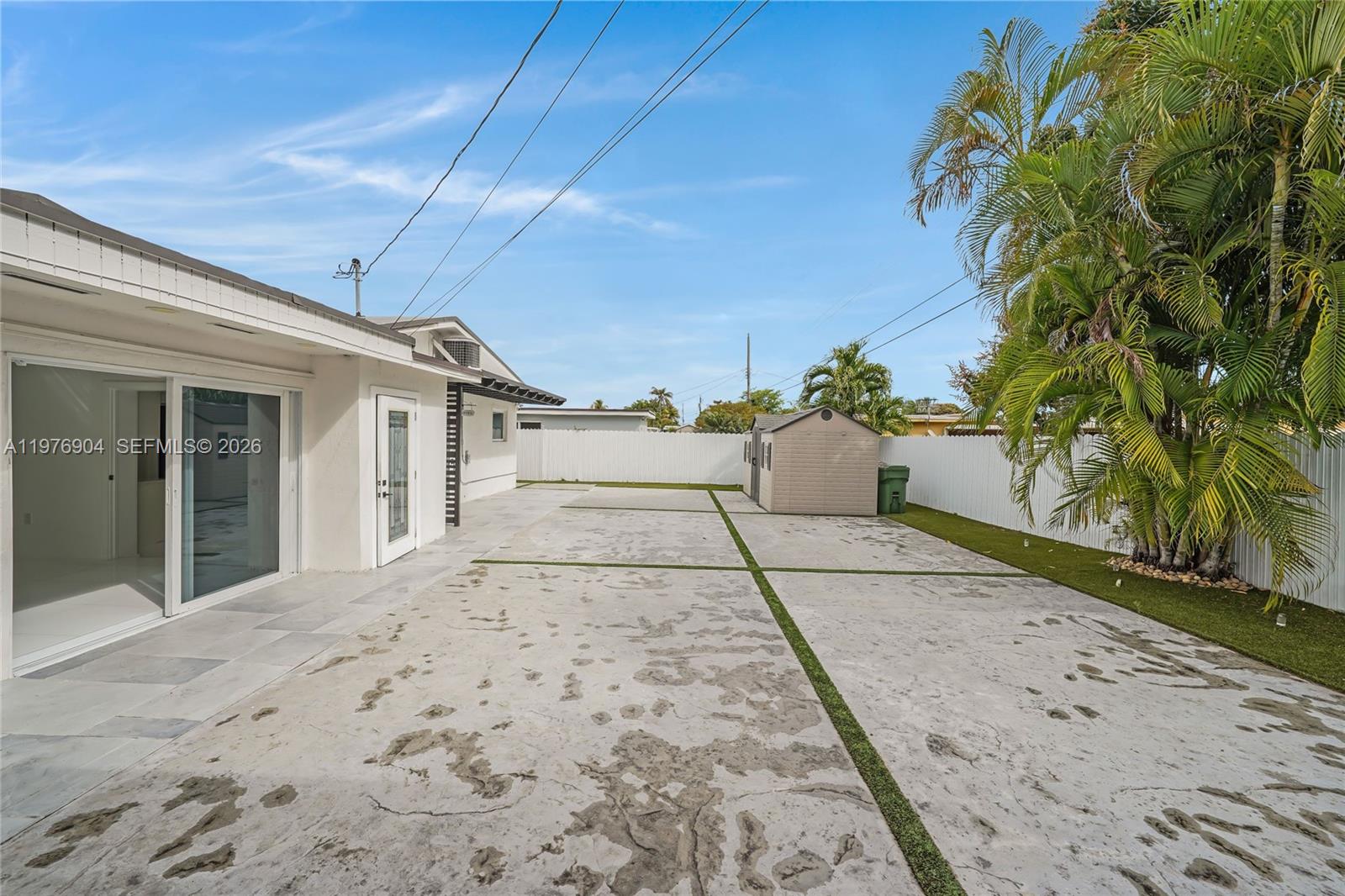 5635 West 13th Court Hialeah, FL 33012 - Photo 30 of 47 a view of a white house with a yard