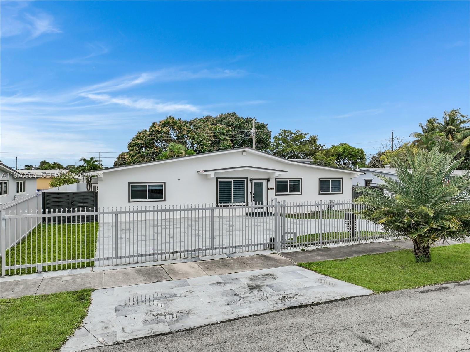 5635 West 13th Court Hialeah, FL 33012 - Photo 3 of 47 a front view of a house with a yard