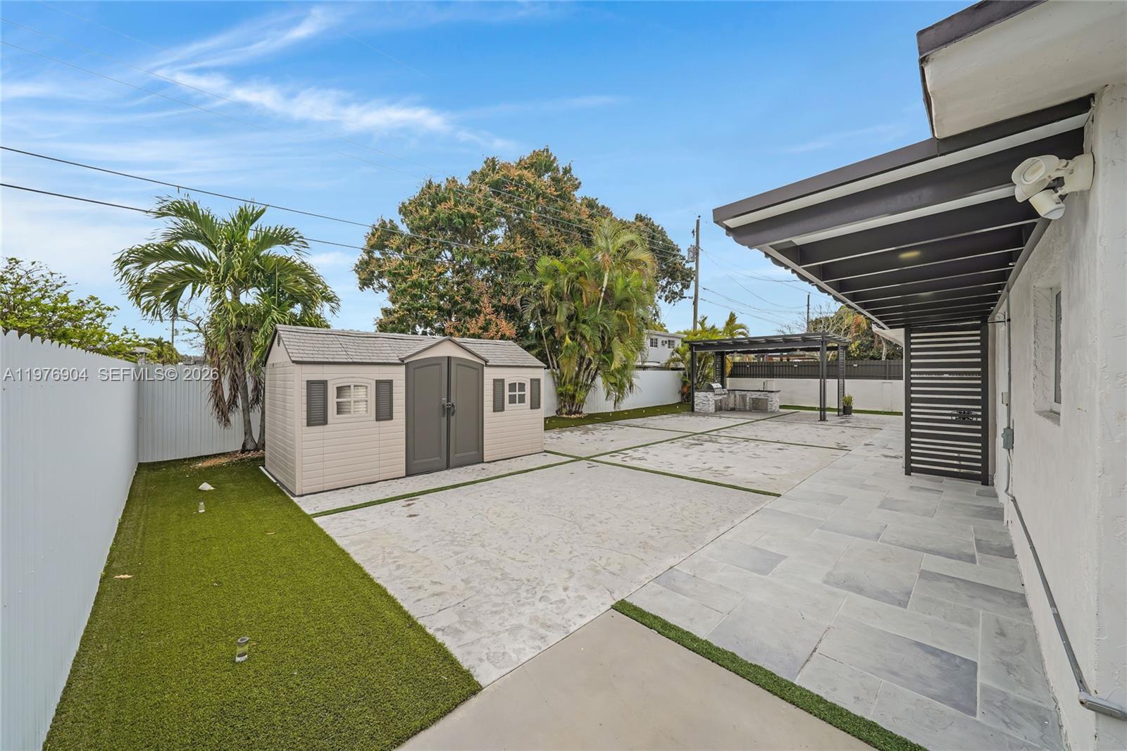 5635 West 13th Court Hialeah, FL 33012 - Photo 31 of 47 a house with palm tree in front of it