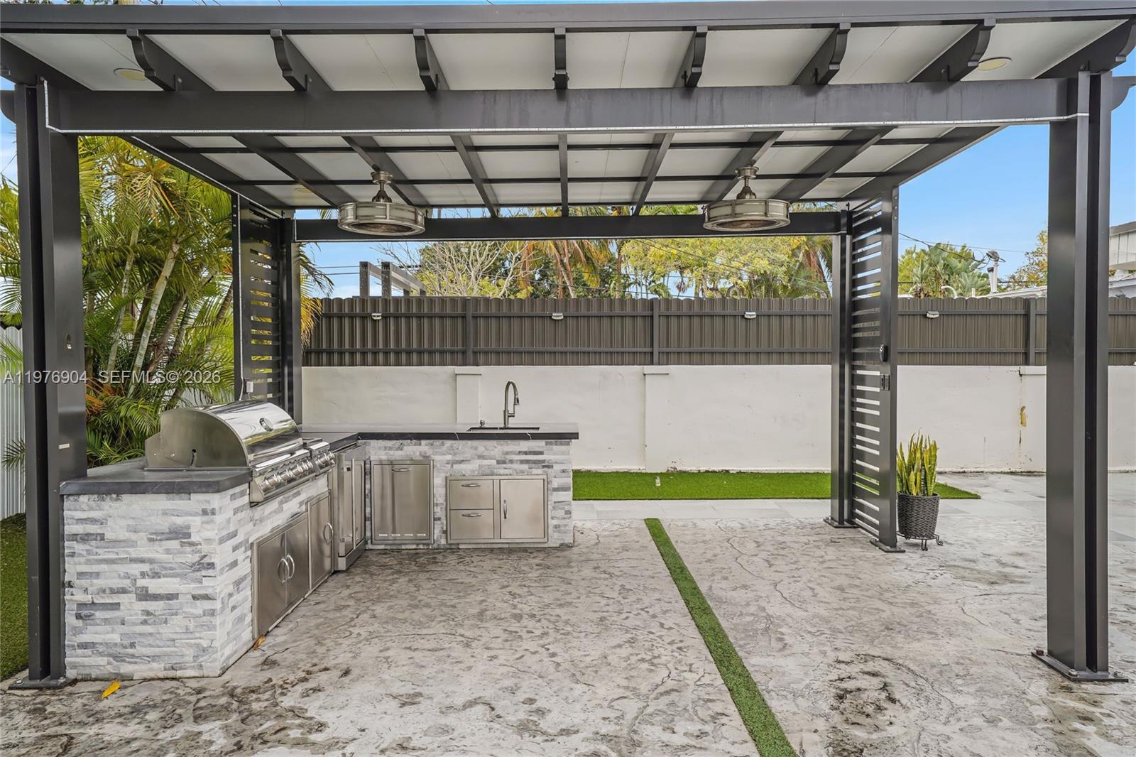 5635 West 13th Court Hialeah, FL 33012 - Photo 33 of 47 a view of a porch with a table and chairs