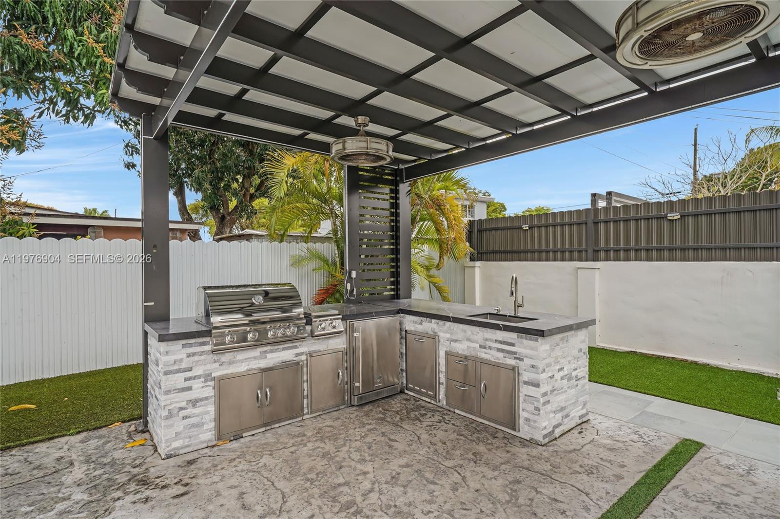 5635 West 13th Court Hialeah, FL 33012 - Photo 35 of 47 a kitchen with a stove a sink and a refrigerator