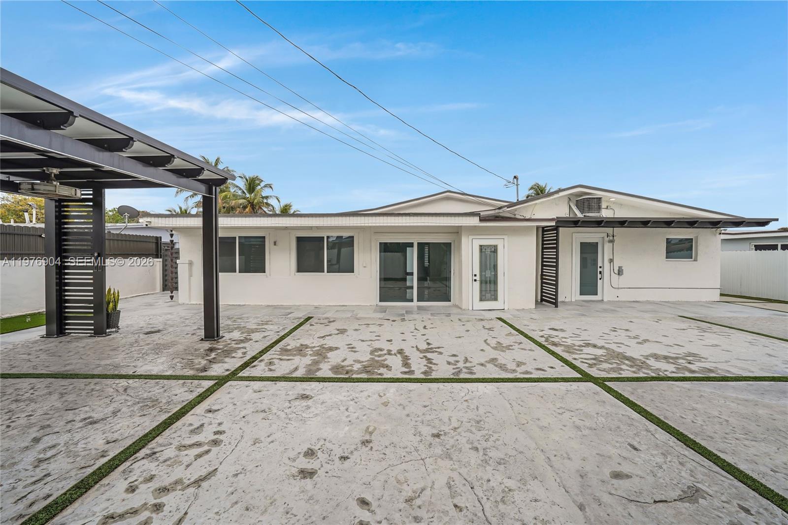 5635 West 13th Court Hialeah, FL 33012 - Photo 38 of 47 a front view of a house with a garden