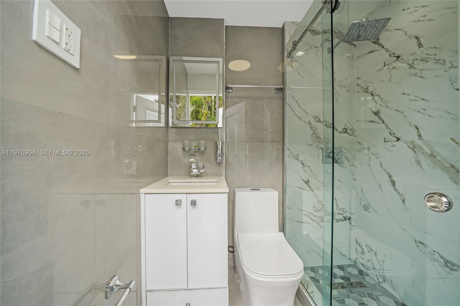 5635 West 13th Court Hialeah, FL 33012 - Photo 39 of 47 a bathroom with a toilet a sink and shower