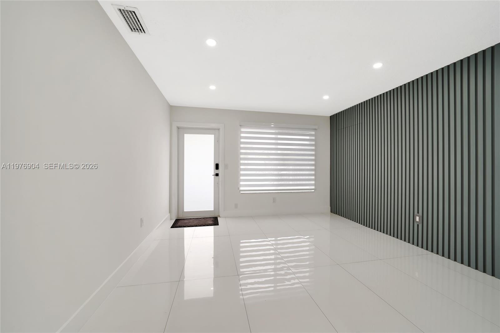 5635 West 13th Court Hialeah, FL 33012 - Photo 4 of 47 a view of an empty room with a window