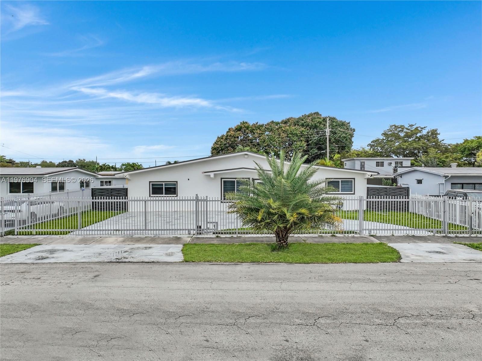 5635 West 13th Court Hialeah, FL 33012 - Photo 41 of 47 a big house with a big yard and large trees