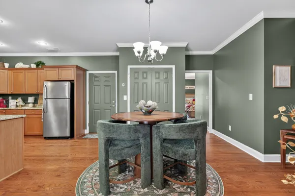 a dining room filled with furniture and a chandelier